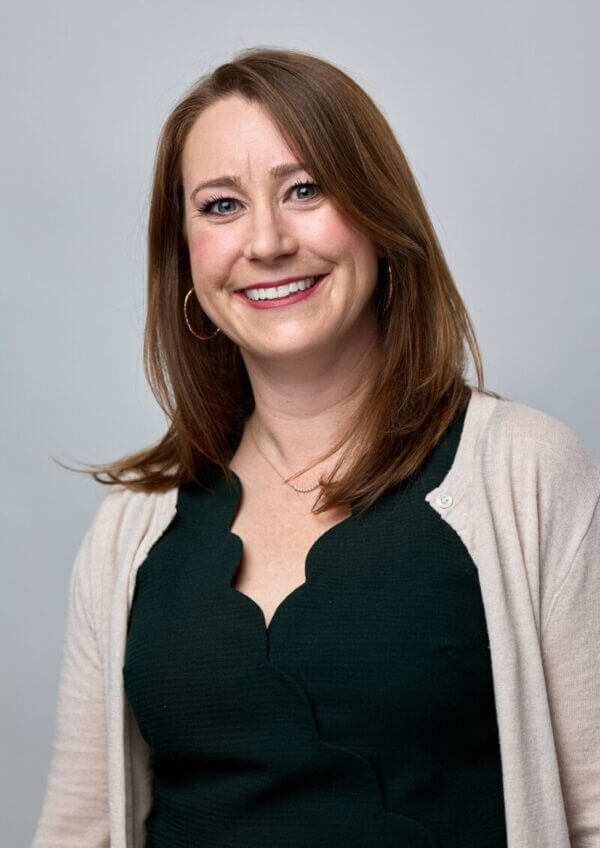 Smiling woman in a suit jacket and a blouse