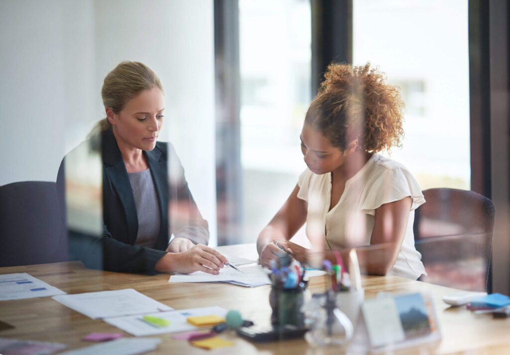 Two women collaborating at a desk.