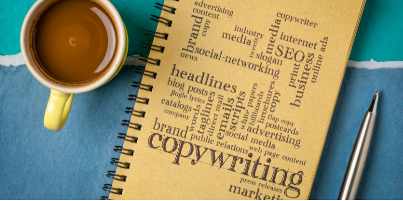 Coffee, notebook with writing terms, and a pen.