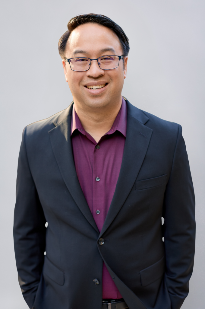 Smiling man in suit and glasses