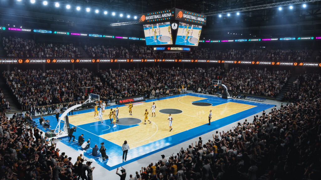 Wide view of a basketball game in an arena with players and a full crowd.