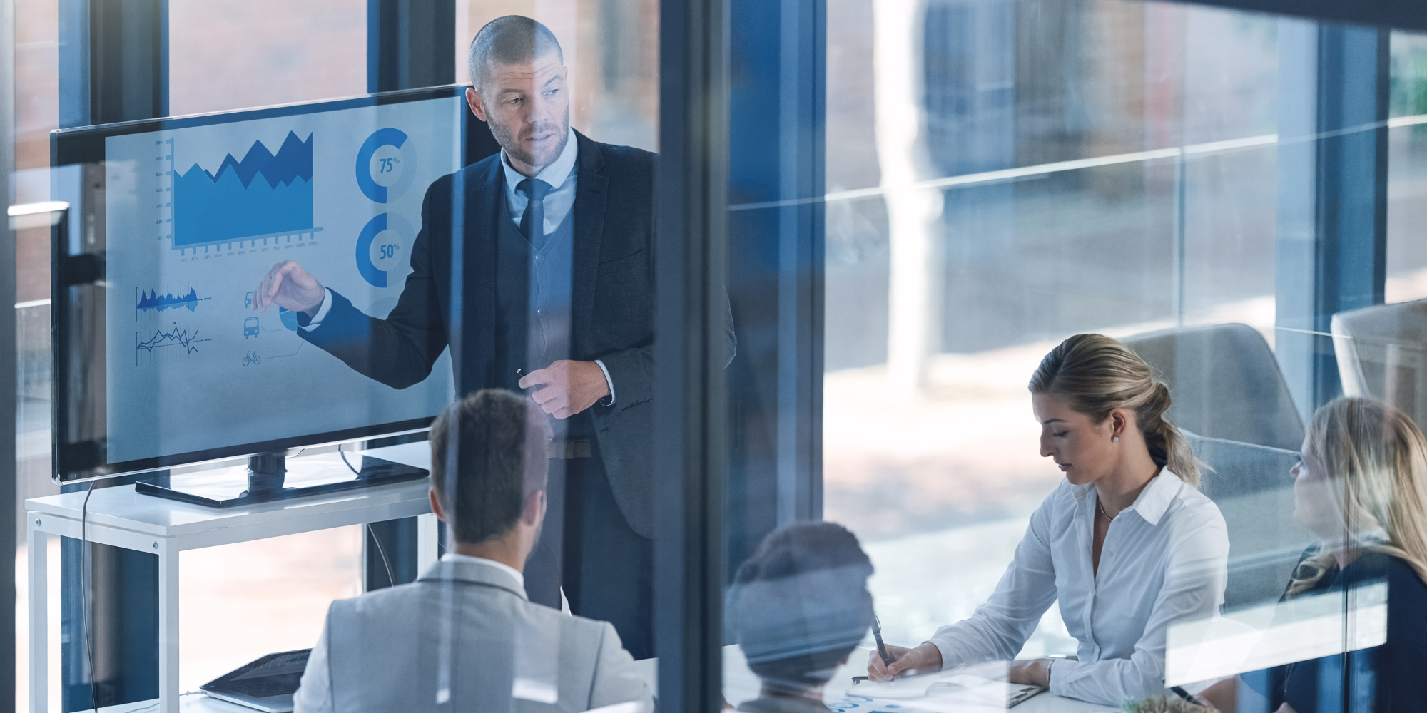 Businessman presenting data charts to colleagues in meeting